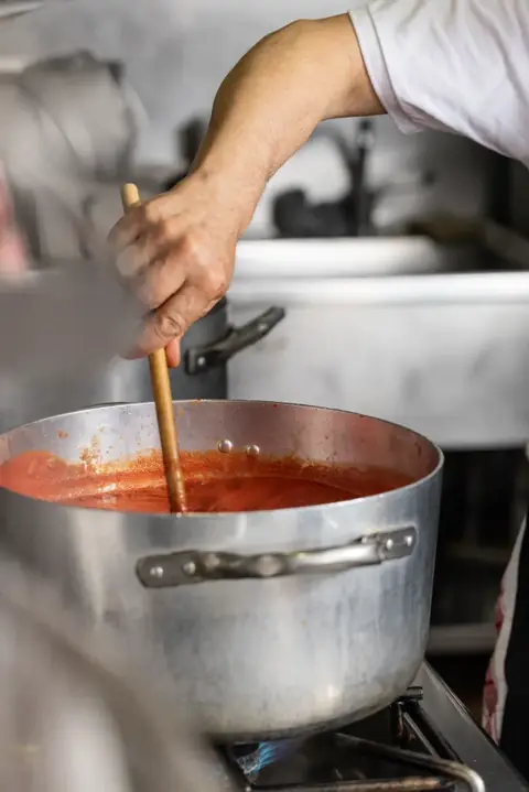 Il sugo di pomodoro che cuoce nel pentolone in cucina